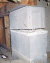 Concrete crawl space support posts in Arnold that are showing signs of failure as they sink into the earth.
