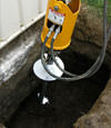 Installing a helical pier during a foundation repair in Florissant