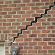 stair step cracking reaching from a window along the foundation wall in St. Charles