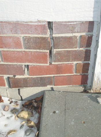 Severe street creep damage to a garage wall outside a Washington home