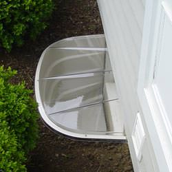 A vinyl basement window and covered window well in Charleston