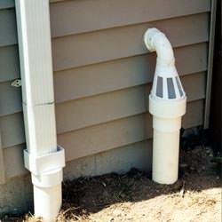 A grated sump pump discharge line fitting in Paducah
