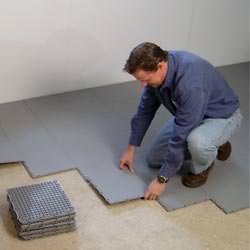 basement sub floor tiles being installed by a contractor in Jacksonville