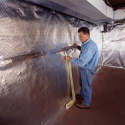 Installation of a radiant heat and vapor barrier on a basement wall in O'Fallon, IL