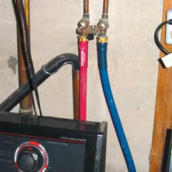 Washer hoses in a basement  in Troy