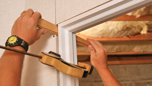 Installing trim and finishing touches to a remodeled basement in St. Peters, MO & IL