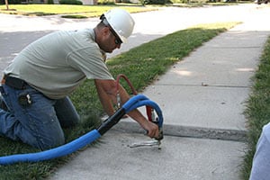 Technician raising sidewalk with PolyLevel®