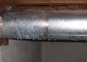 condensation collecting on an HVAC vent in a humid Ballwin basement